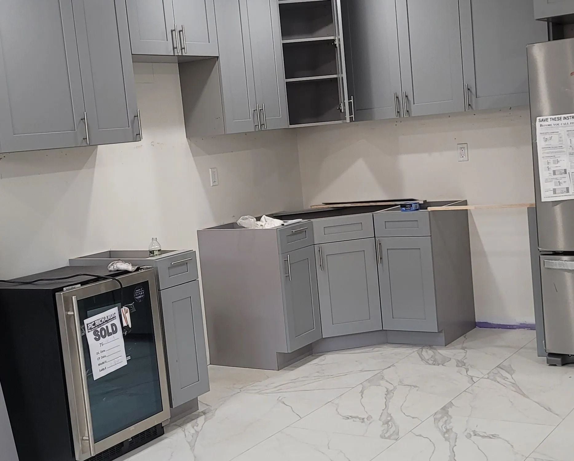 Modern kitchen, full-wall composition — marble waterfall island, integrated appliance package