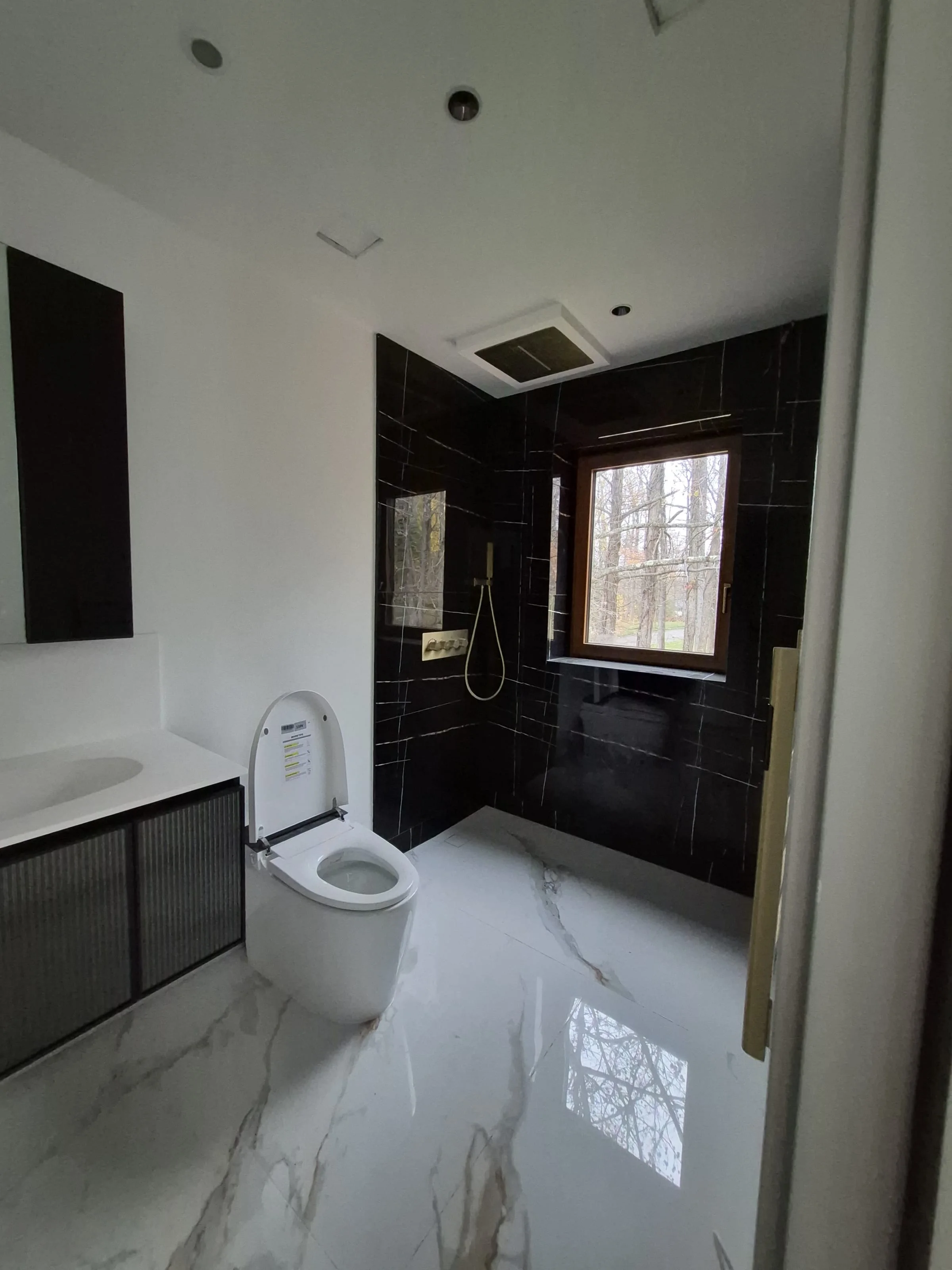 Smart-bath fixture detail — wall-hung toilet with integrated bidet and remote control